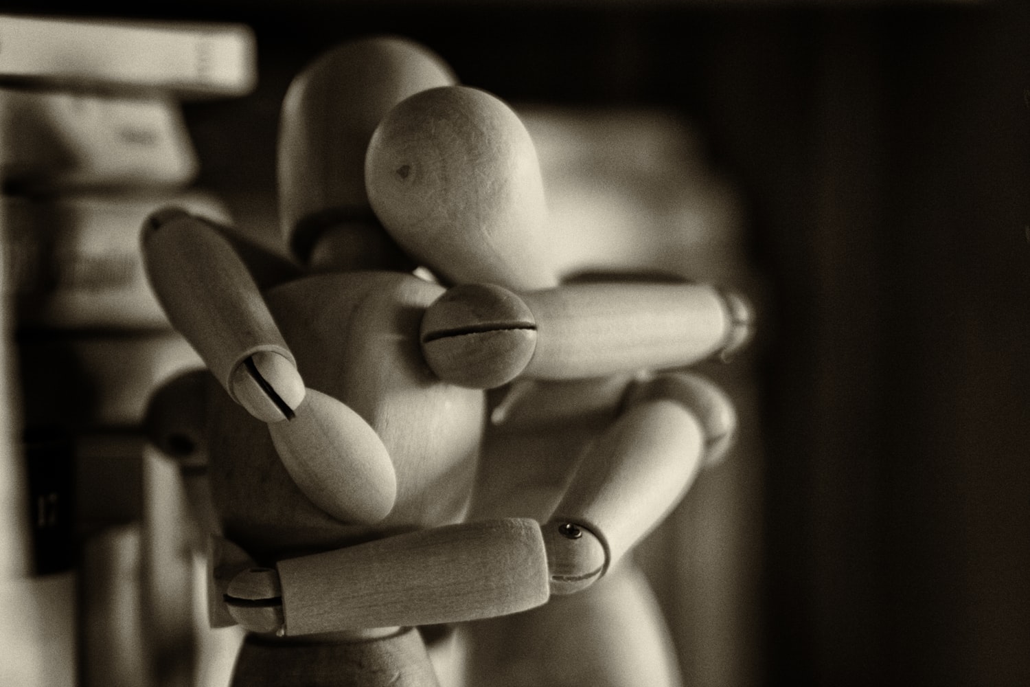 Image of a wooden articulated art mannequin embracing